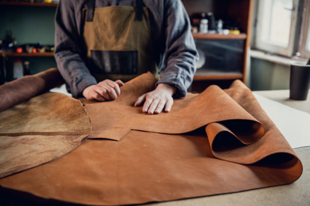 Man putting out fabric, measuring it.